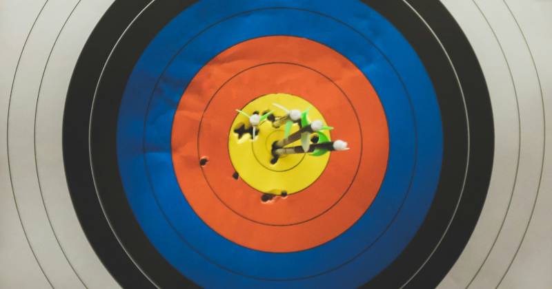 A target with arrows grouped in the center