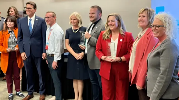 Kenley Steck and Stacee McIff receive award on behalf of Snow College