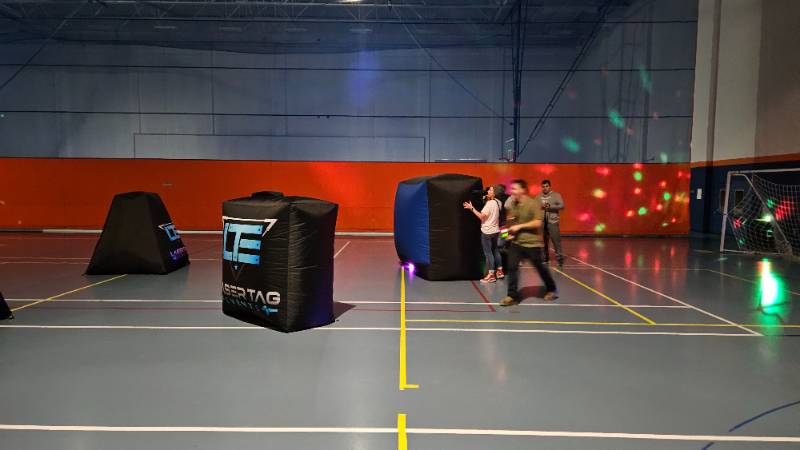 Laser Tag with blow up obstacles in the blue gym at Snow College